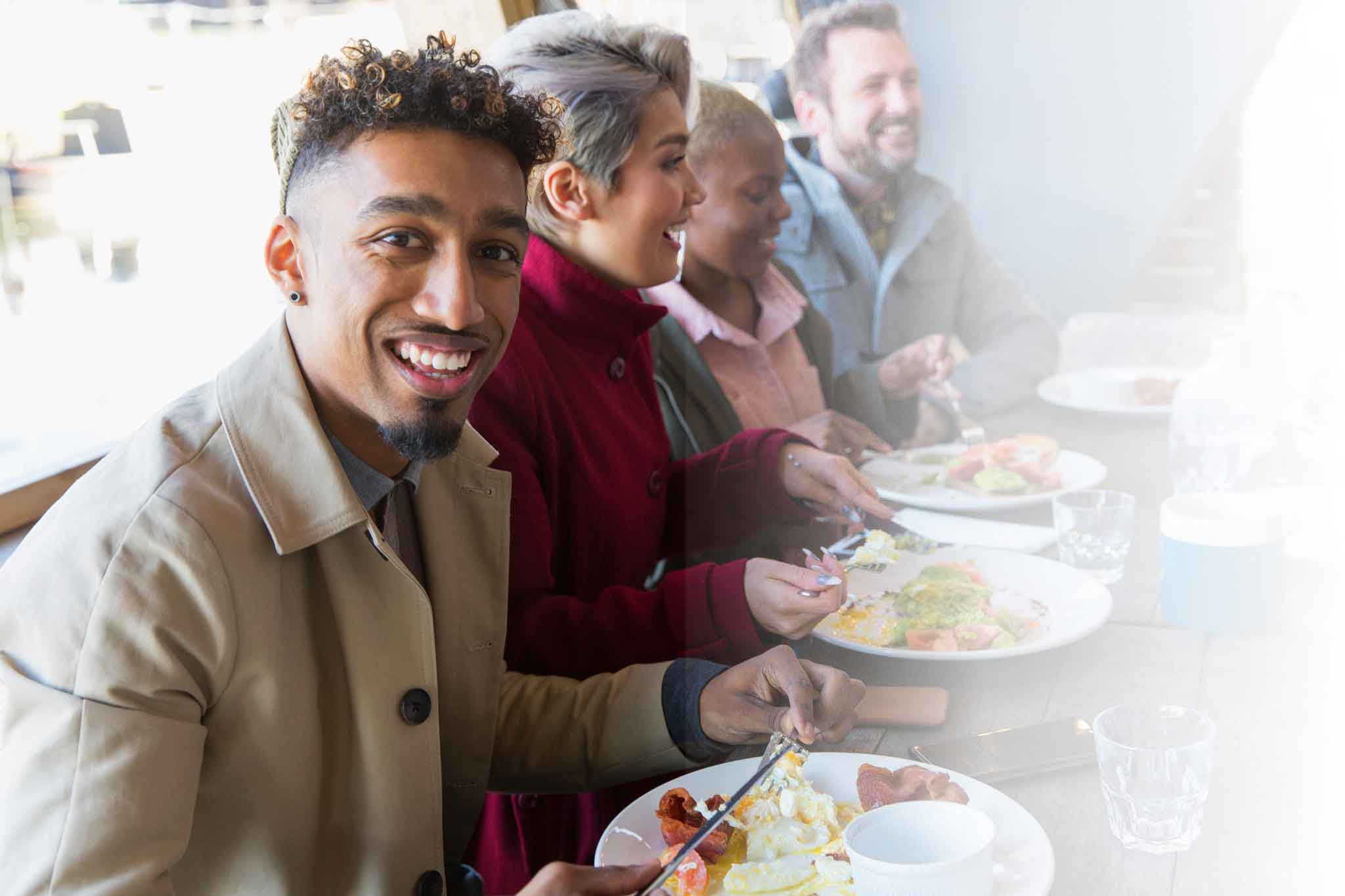 Man having lunch at a table with friends